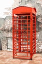 Red telephone box front brick wall block. Royalty Free Stock Photo