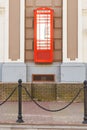 Red telephone box icon London, suspended on the wall of the house. Vintage style of a typical red phone booth Royalty Free Stock Photo