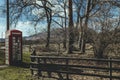 Red telephone box on a side of a road in the countryside in the UK Royalty Free Stock Photo