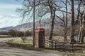 Red telephone box on a side of a road in the countryside in the UK Royalty Free Stock Photo