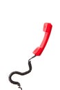 Red telephone handset with curly cord isolated on white Royalty Free Stock Photo