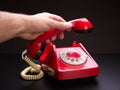 Red telephone handset in hand Royalty Free Stock Photo