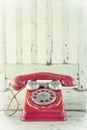 Red telephone on wooden chair Royalty Free Stock Photo