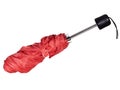 Red telescopic umbrella, part furled. Isolated on white background.