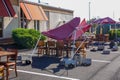 Red tent over a dining table collapsed due to high winds at a restaurant parking lot with outdoor seating due to COVID-19 Royalty Free Stock Photo