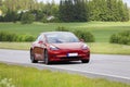 Red Tesla Model 3 Electric Car on Road Royalty Free Stock Photo