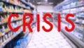 Red text CRISIS on Abstract blur image of supermarket background. Word. Bar charts and graphs. Rising food prices. Inflation