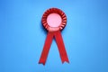 Red award rosette with ribbons