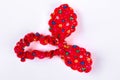 Red textile hair scrunchy with a pattern of flowers.