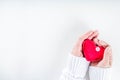 Red textile heart in girls hands from above Royalty Free Stock Photo