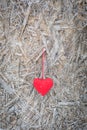 Red textile heart hanging on ice covered background, Valentine`s Day greeting concept Royalty Free Stock Photo