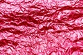 Red texture of crumpled sheet of aluminum foil. Foil background. Royalty Free Stock Photo