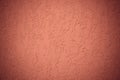 Red texture of wall. Ribbed surface of orange plaster. Corrugated concrete wall. Vignette of background. Modern paper design. Abst Royalty Free Stock Photo