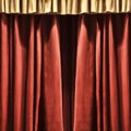 Red theater curtains with beautiful pleats. Background with velvet curtain.