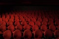 Red theatre seats with black dark shadow on the background.