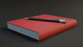 Red thick hardcover notebook with a ball pen placed on it. Isolated.