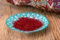 Red Threads And Yellow Style High Grade And Strength Of Dry Saffron Spice On Persian Turquoise Handmade Design Plate On Wooden Ta