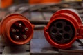 Red three-phase plug and socket with cable. 380 volts. Royalty Free Stock Photo
