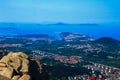 Red-tile roofs shaded in trees among blue sea and clear sky 1