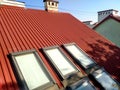 Red tiled house roof with attic windows. Roofing construction, window installation, modern architecture concept