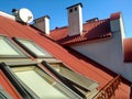 Red tiled house roof with attic windows. Roofing construction, window installation, modern architecture concept Royalty Free Stock Photo