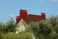 Red tiled roof of a private house with three metal chimneys Royalty Free Stock Photo