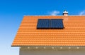 Red tiled roof with solar thermal plant and chimney Royalty Free Stock Photo