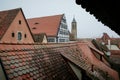 Red tiled roofs, stone gothic towers, fog, renaissance and gothic historical buildings, old town, medieval street, half-timbered Royalty Free Stock Photo