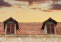 Red tiled rooftop of an old house of Trebinje, Bosnia and Herzegovina on the background of sunset sky