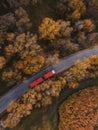 Red tipper truck on street road highway transportation. Semi-truck autumn countryside aerial view Royalty Free Stock Photo