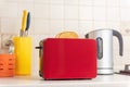 Red toaster with ready toasts in the kitchen.