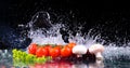 Red tomato cherry, mushrooms and green fresh salad with water drop splash Royalty Free Stock Photo