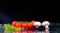 Red tomato cherry, mushrooms and green fresh salad with water drop splash Royalty Free Stock Photo