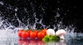 Red tomato cherry, mushrooms and green fresh salad with water drop splash Royalty Free Stock Photo