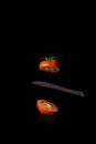 Red tomato cut in half on black background Royalty Free Stock Photo