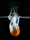 Tomato immersed in water, on black background Royalty Free Stock Photo