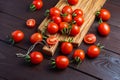 Red tomato in glass bowl on cutting board on wooden table. Organic healthy food. Cooking Ingredients Royalty Free Stock Photo