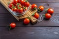 Red tomato in glass bowl on wooden table. Organic healthy food. Cooking Ingredients.Pomodoro on desk Royalty Free Stock Photo