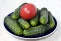 Red tomato on green cucumbers fresh vegetables Royalty Free Stock Photo