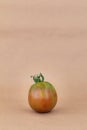 Red tomato isolated on beige color background