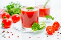 Red tomato juice in transparent glasses with parsley, cutted tom Royalty Free Stock Photo