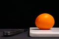 Red tomato and knife on a black background Royalty Free Stock Photo