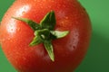 Red tomato macro over green background