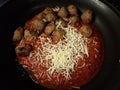 Red tomato pasta sauce and meatballs with cheese in skillet or pan Royalty Free Stock Photo