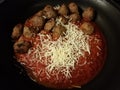 Red tomato pasta sauce and meatballs with cheese in skillet or pan Royalty Free Stock Photo