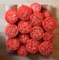 Red Tomato Slices on a Wooden Cutting Board Royalty Free Stock Photo