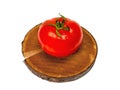 Red tomato on wooden natural stand isolated on white background. Screensaver kitchen vegetables