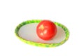 Red tomatoe on the plate Royalty Free Stock Photo