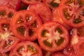 Red tomatoes background. Top view. Healthy natural food, background. Tomatoes slices. Group of ripe tomatoes forming a background. Royalty Free Stock Photo