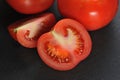 red tomatoes on a black background